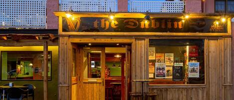 A wooden pub entrance with a sign reading "the Dublin Irish Pub".
