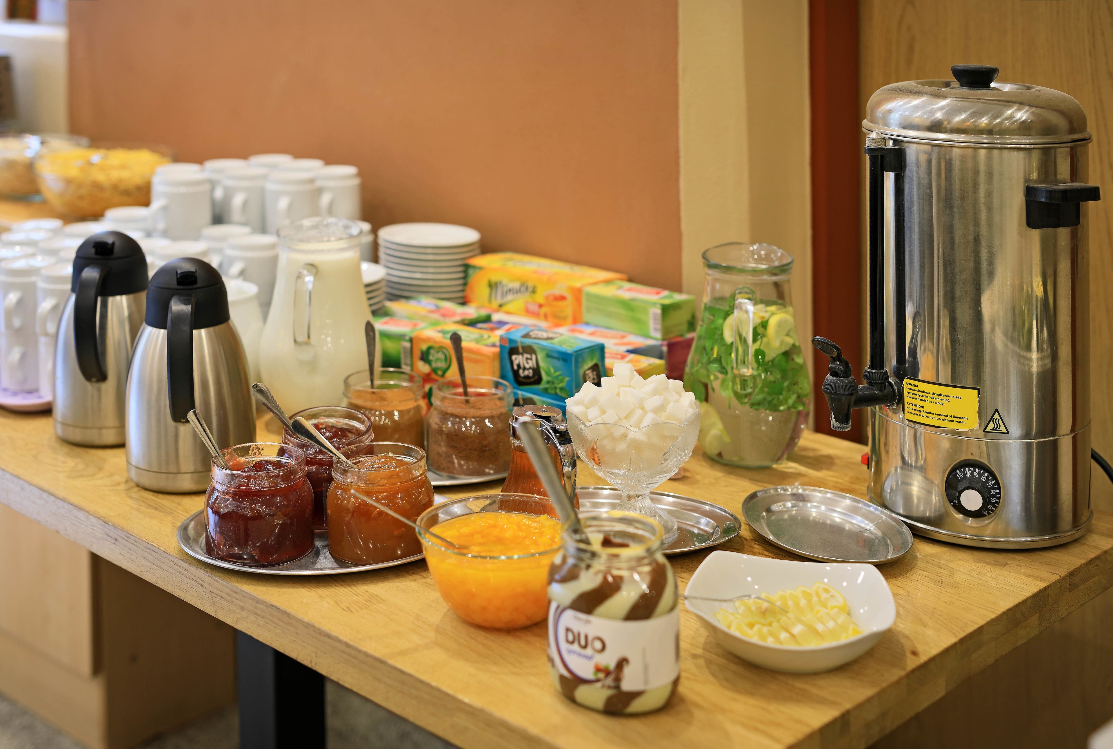 A breakfast buffet with various food items and a coffee maker.