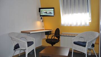 Comfort Triple Room | Living area | Flat-screen TV