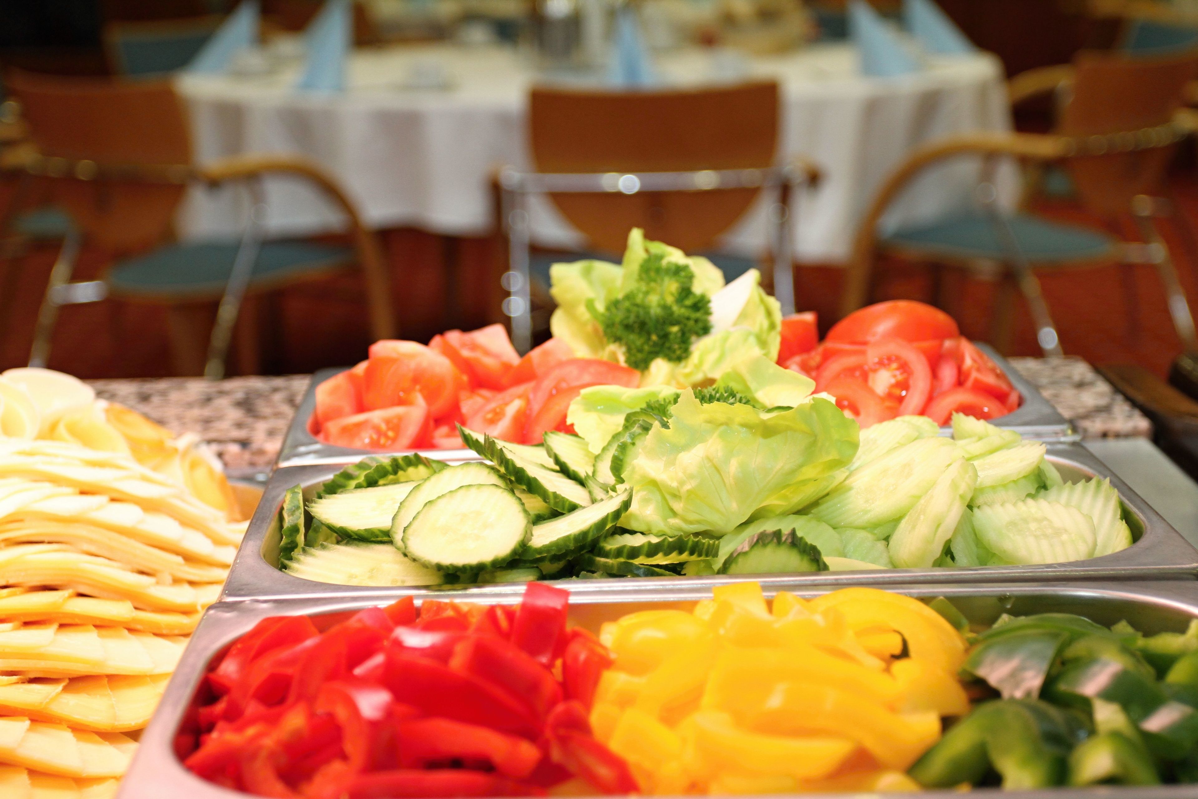 A buffet with various vegetables and fruits.