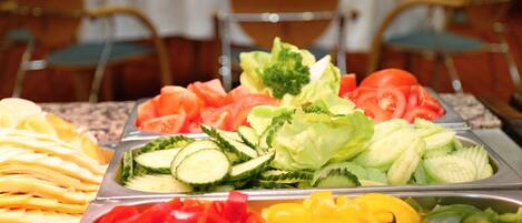 A buffet with various vegetables and fruits.
