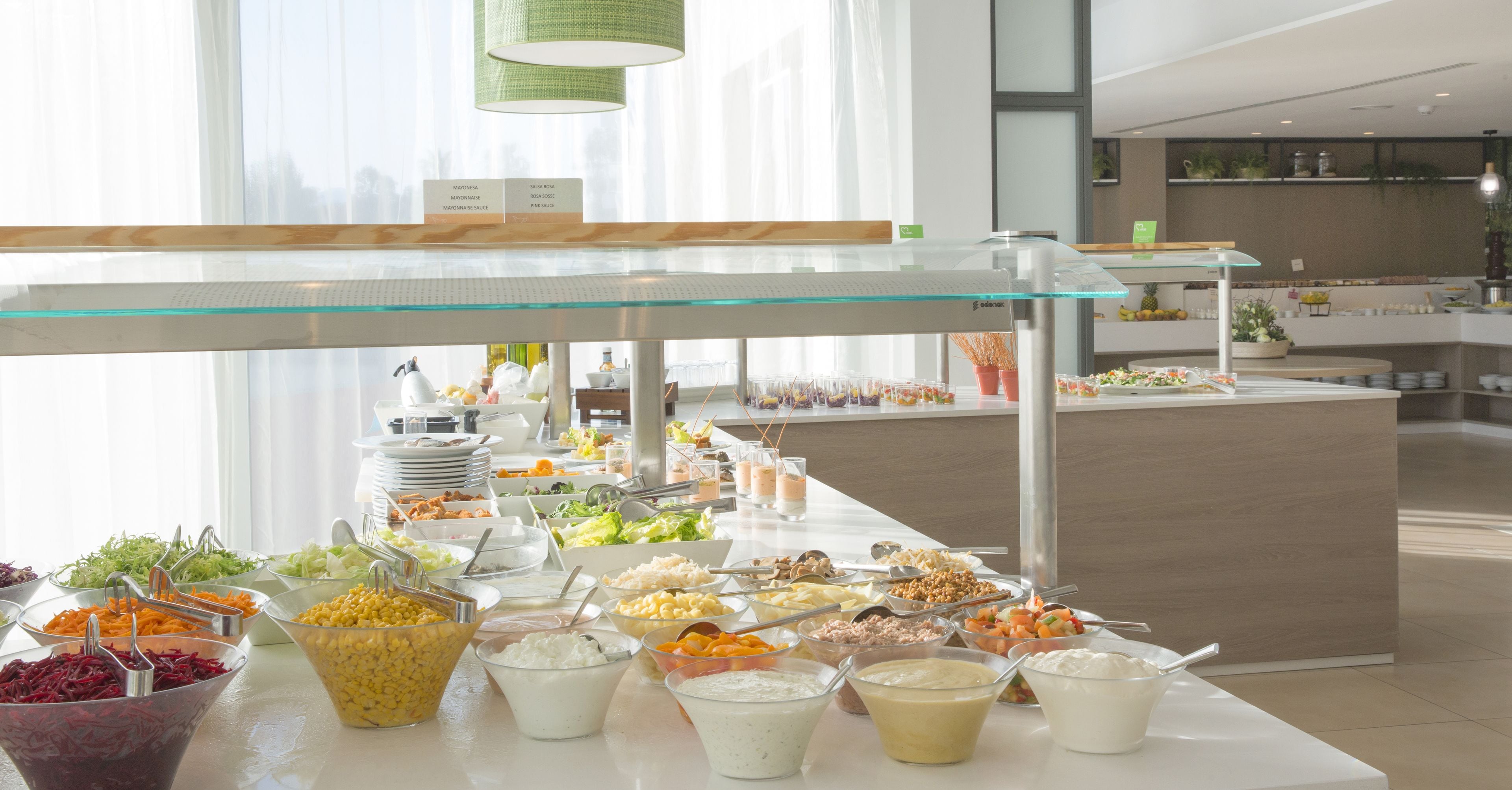 A buffet area with various food options and a glass display case.