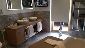 A modern bathroom with two sinks, a bathtub, and a large window. - Vergeiner (Seefeld in Tirol)