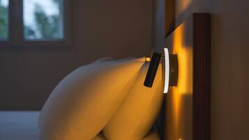 A modern bed with a headboard that has a built-in light fixture.