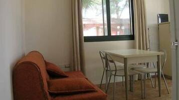 Apartment, 1 Bedroom, Patio | Living area | Flat-screen TV