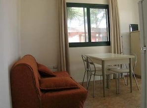 Apartment, 1 Bedroom, Patio | Living area | Flat-screen TV - Villaggio Mithos (Misano Adriatico)