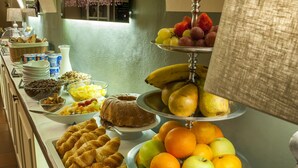 A buffet with various food items including fruits, pastries, and dairy products.
