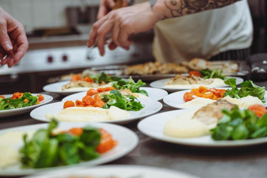 A chef's hands preparing food on a kitchen counter.