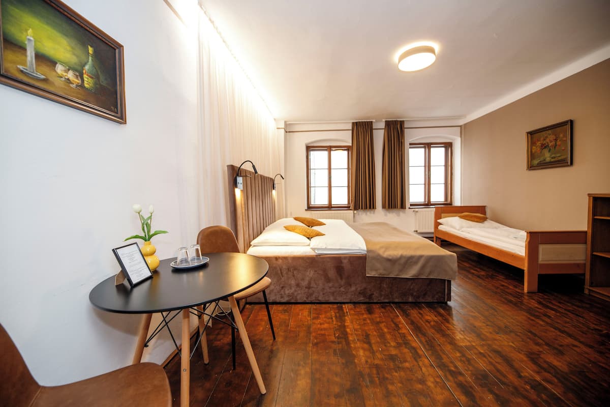 A room with a bed, a table, and a chair.