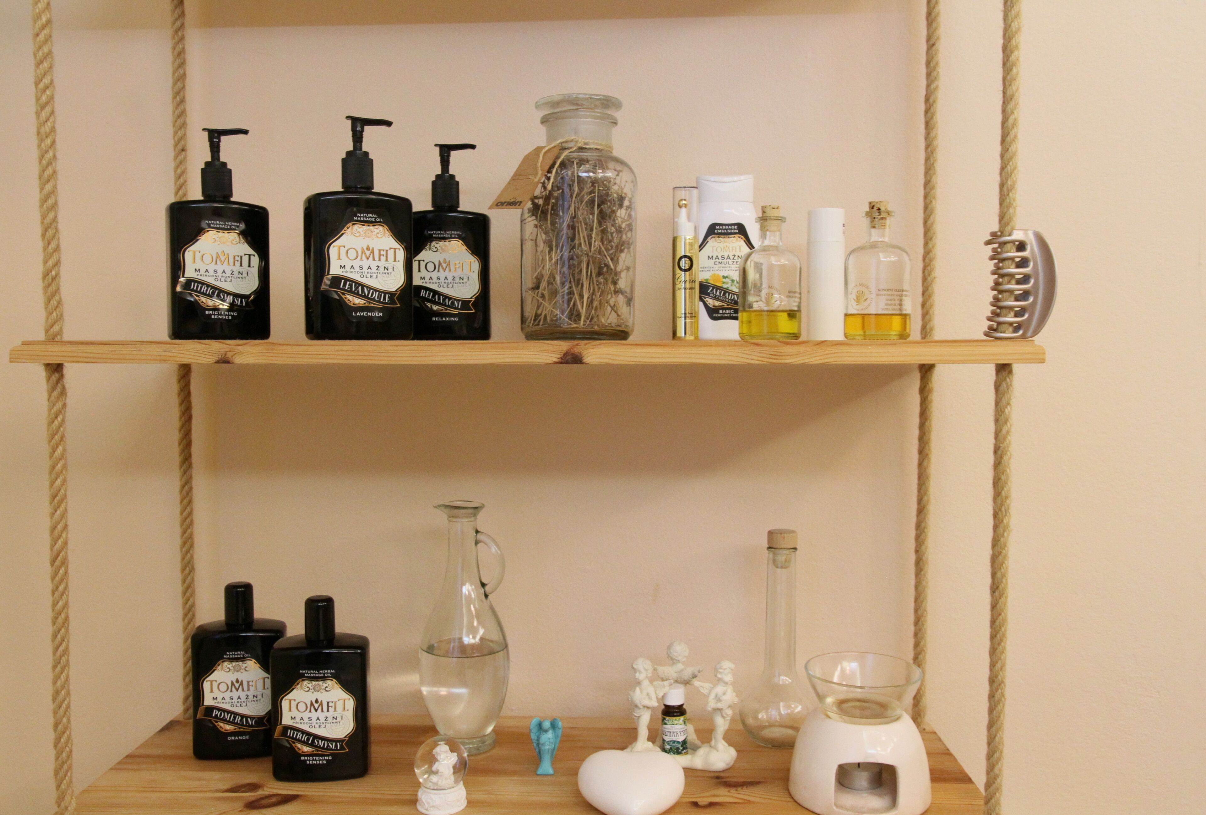 A shelf with various toiletries including bottles of TomFi, a glass jar, and a hairbrush.