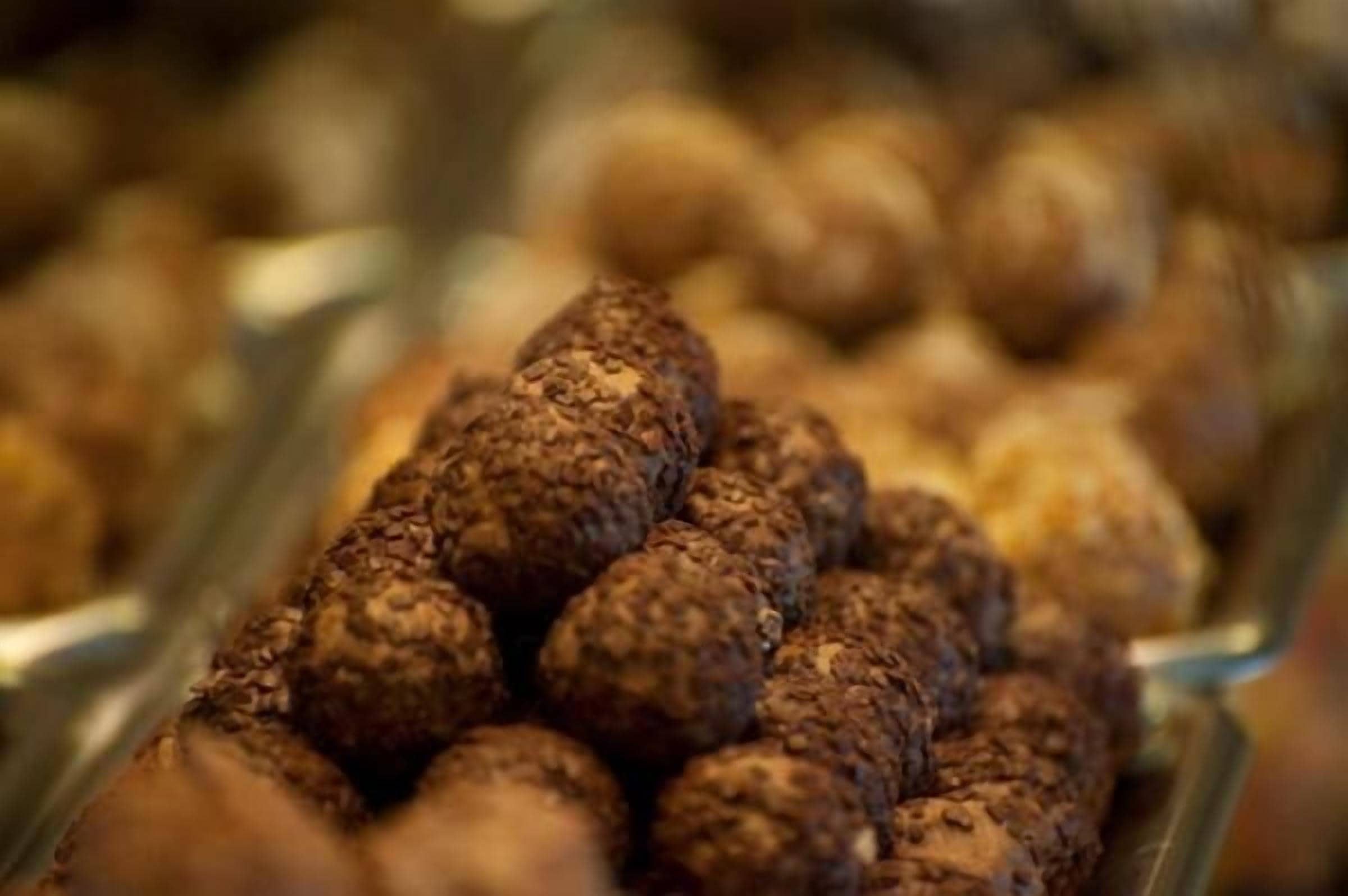 A close-up of chocolate truffles in a tray.