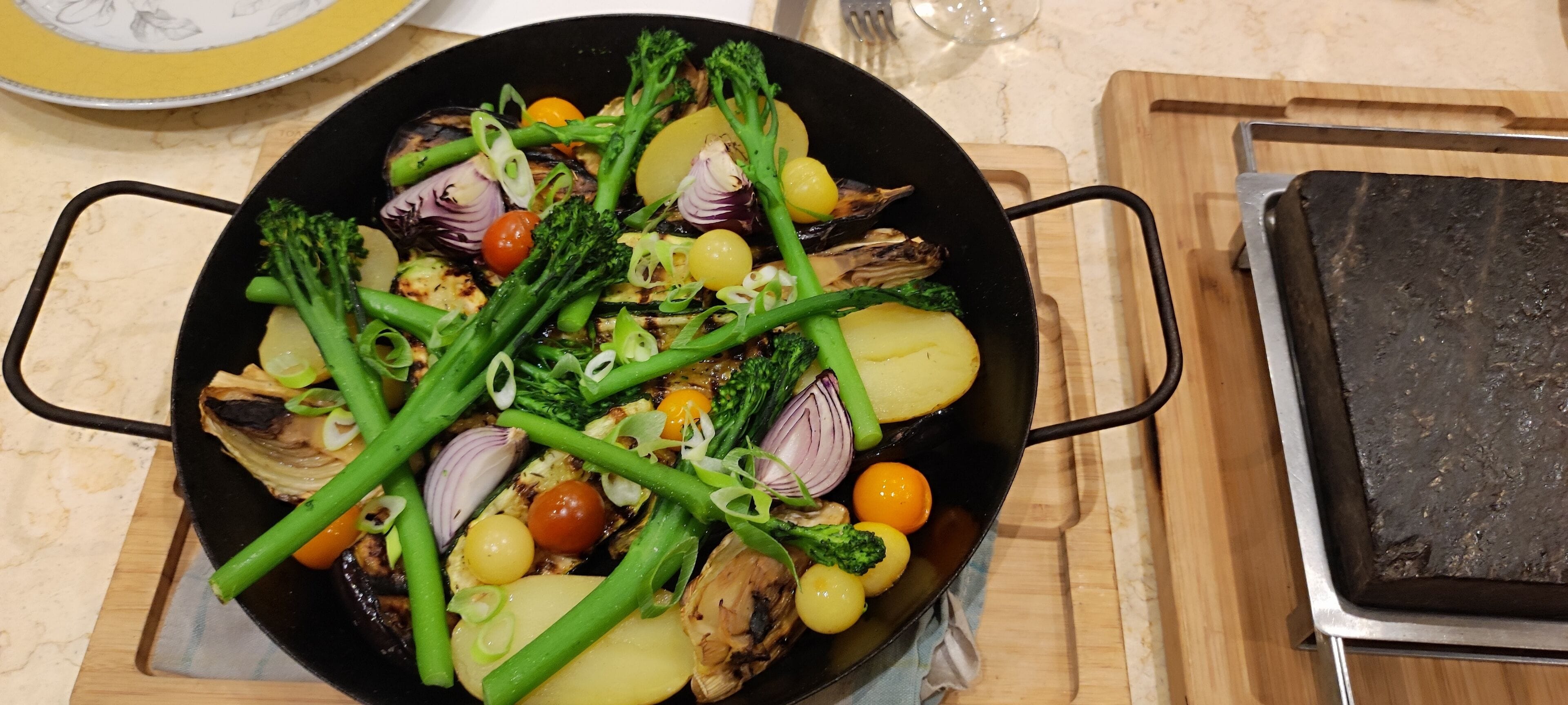 A pan with vegetables on a kitchen counter.