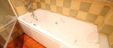 A bathroom with a bathtub, a shower, and a toilet.