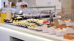 A buffet with various food items and a decorative ship model. - Aluasun Continental Park Hotel & Apartments (Muro)