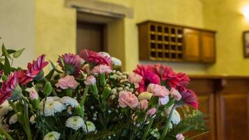 A bouquet of flowers in a room with wooden cabinets and a white door in the background.