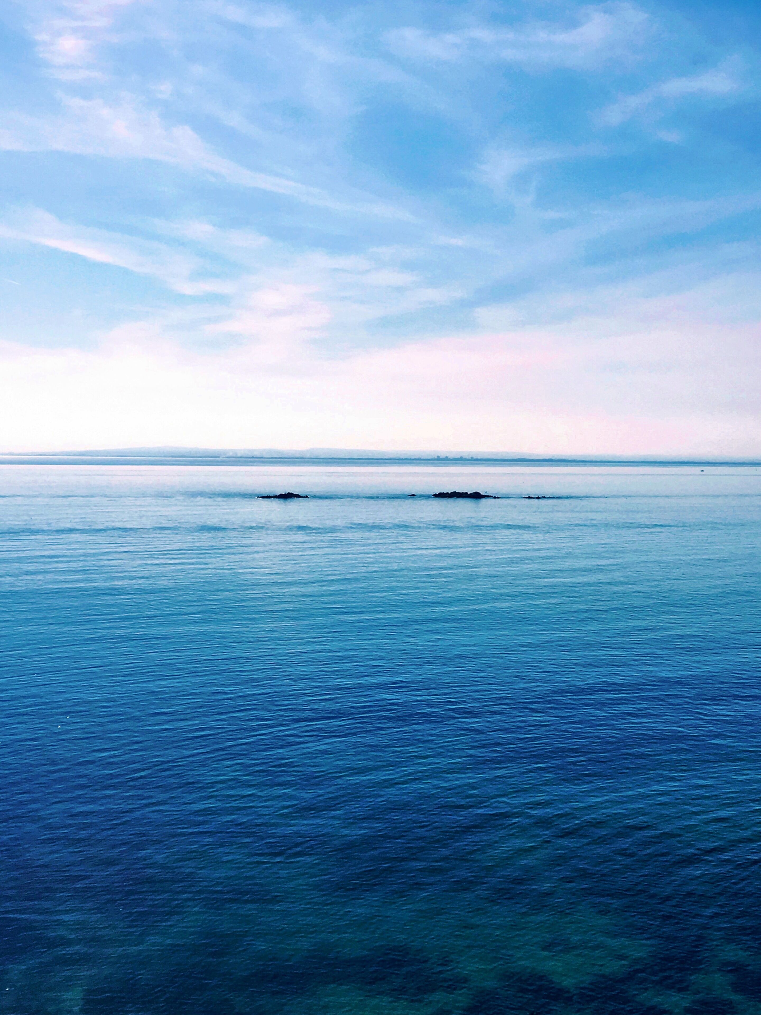 A calm sea with a clear sky.