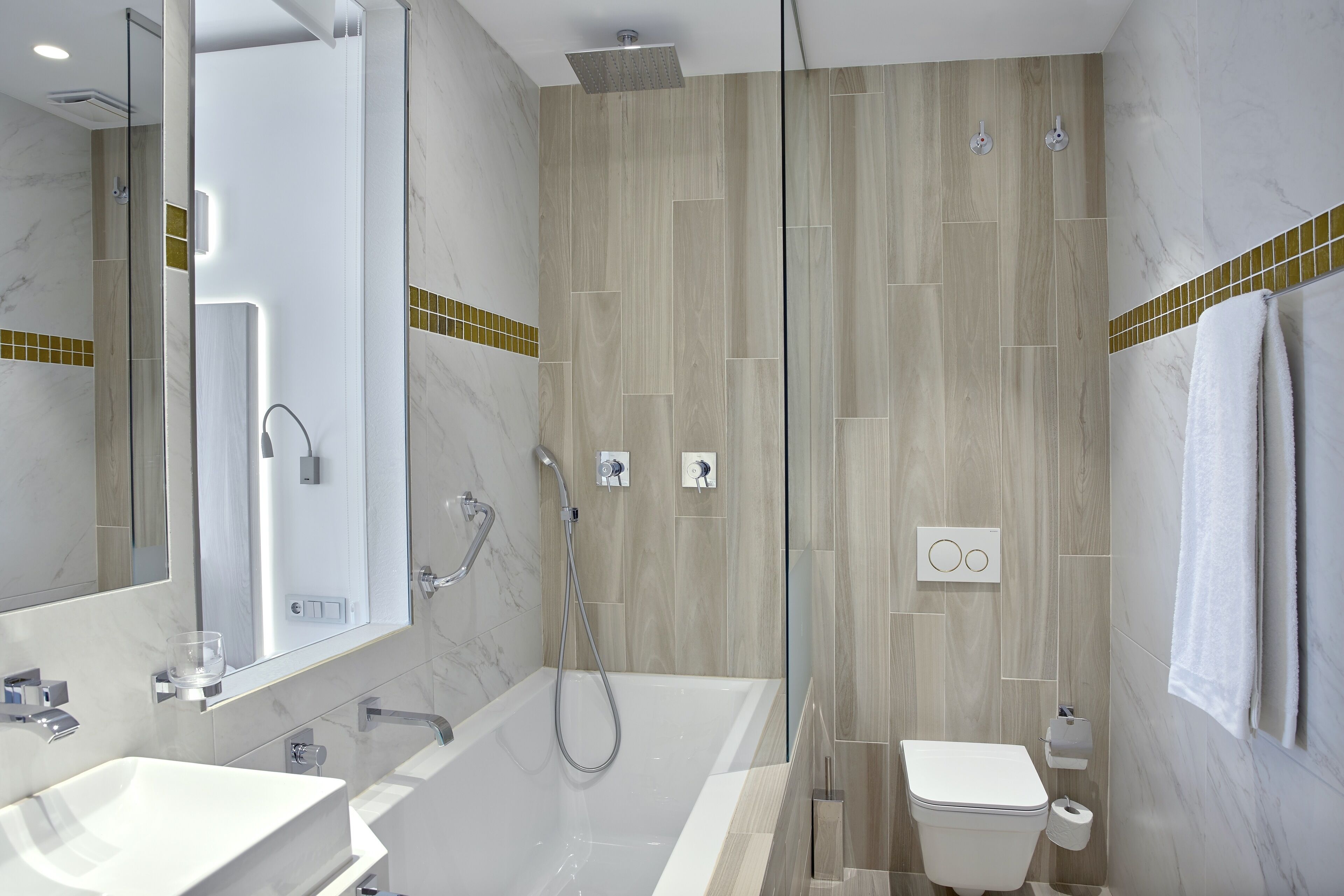 A modern bathroom with a glass-enclosed shower, a bathtub, and a toilet.