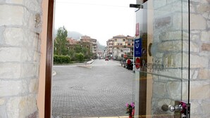 A hotel entrance with a brick archway leading to a paved street. - Hotel Imperion (Parres)