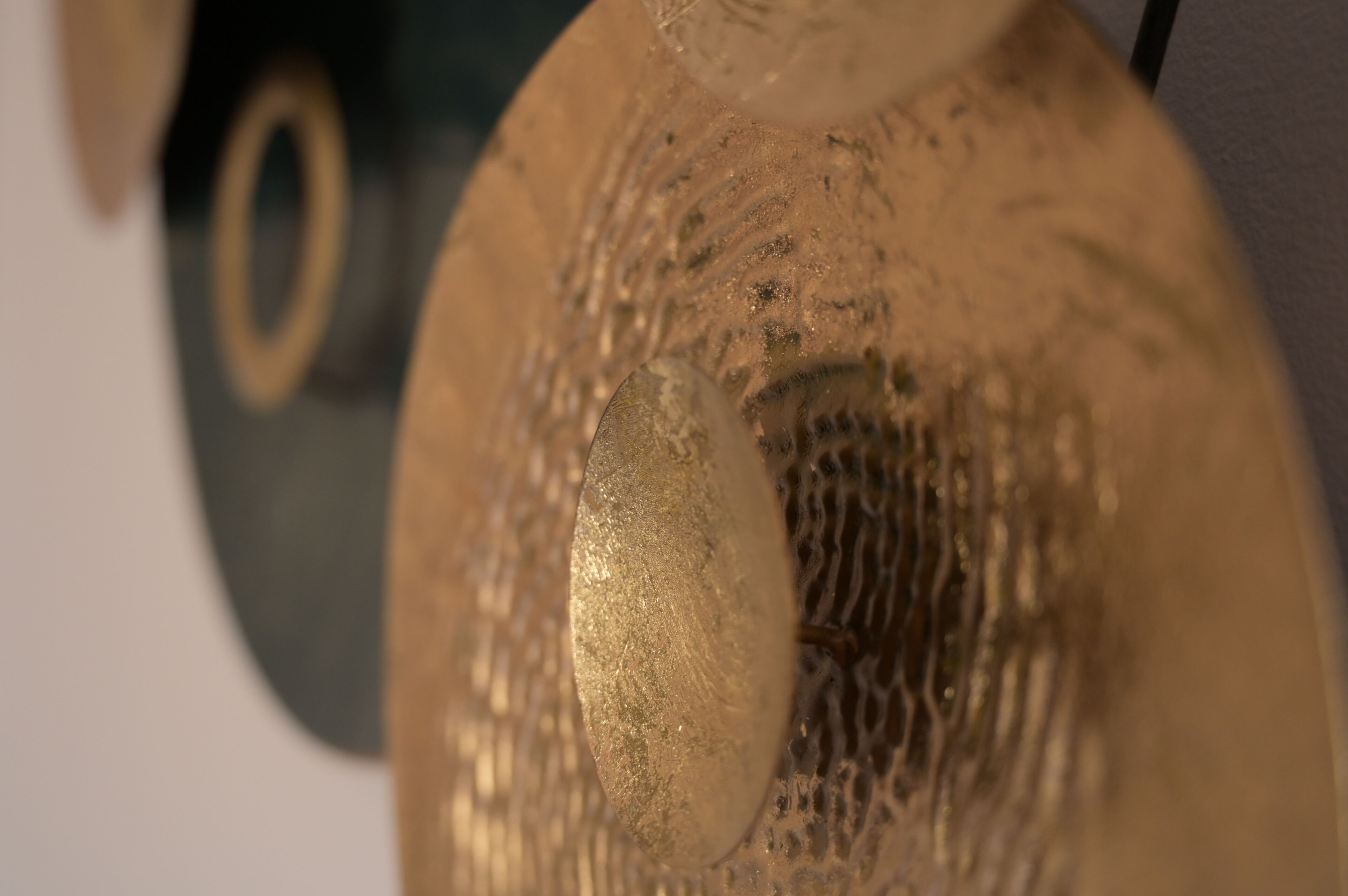 A close-up of a textured, metallic object with a circular feature.
