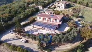 A house with a solar panel array, a swimming pool, and a garden. - I Cardinali (Santa Marinella)