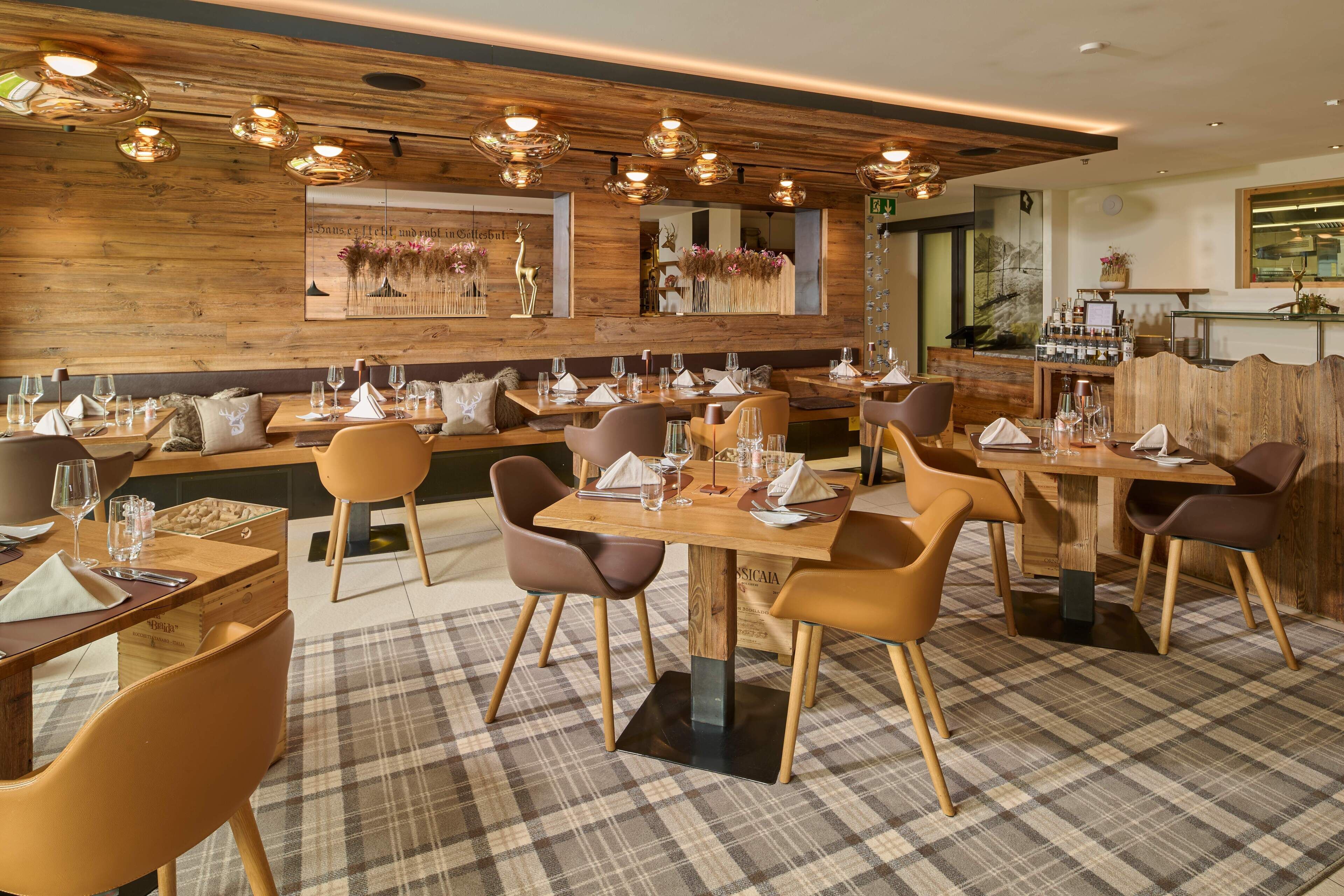 A restaurant with wooden walls, modern lighting, and a checkered floor.