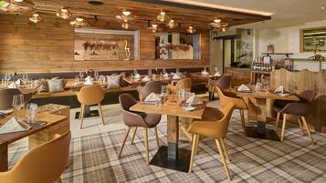 A restaurant with wooden walls, modern lighting, and a checkered floor.