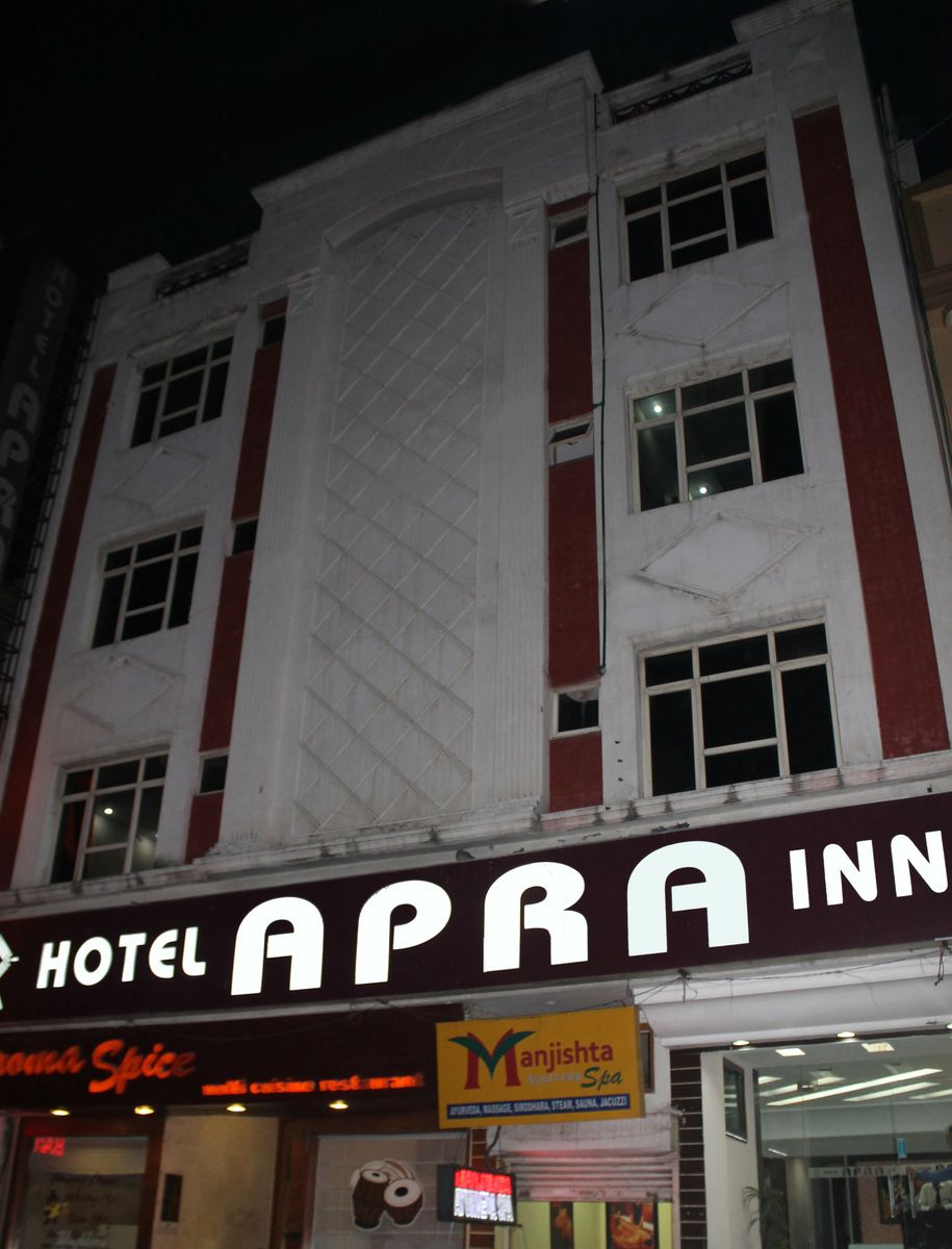 A hotel named "APRA INN" with a sign for "Manjishtha Massage Spa" below it.