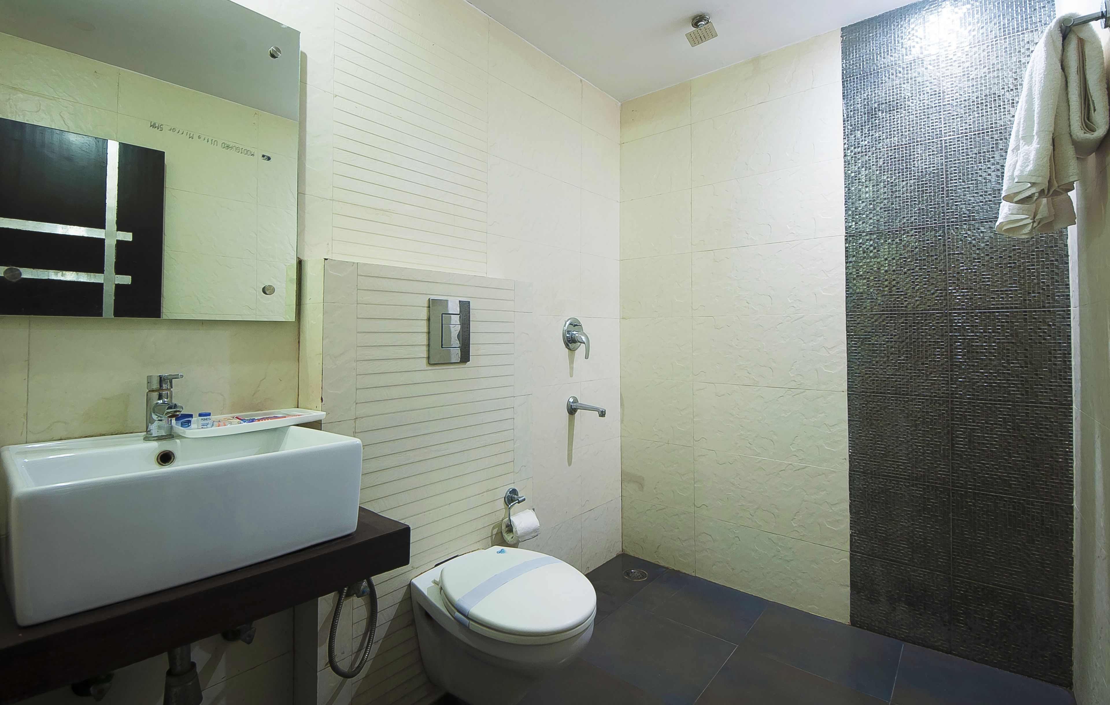 A bathroom with a sink, toilet, and shower.