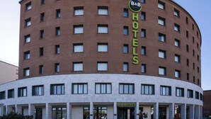 A B&B hotel with a curved facade, multiple windows, and a prominent 'HOTELS' sign. - B&B Hotel Sassuolo (Sassuolo)