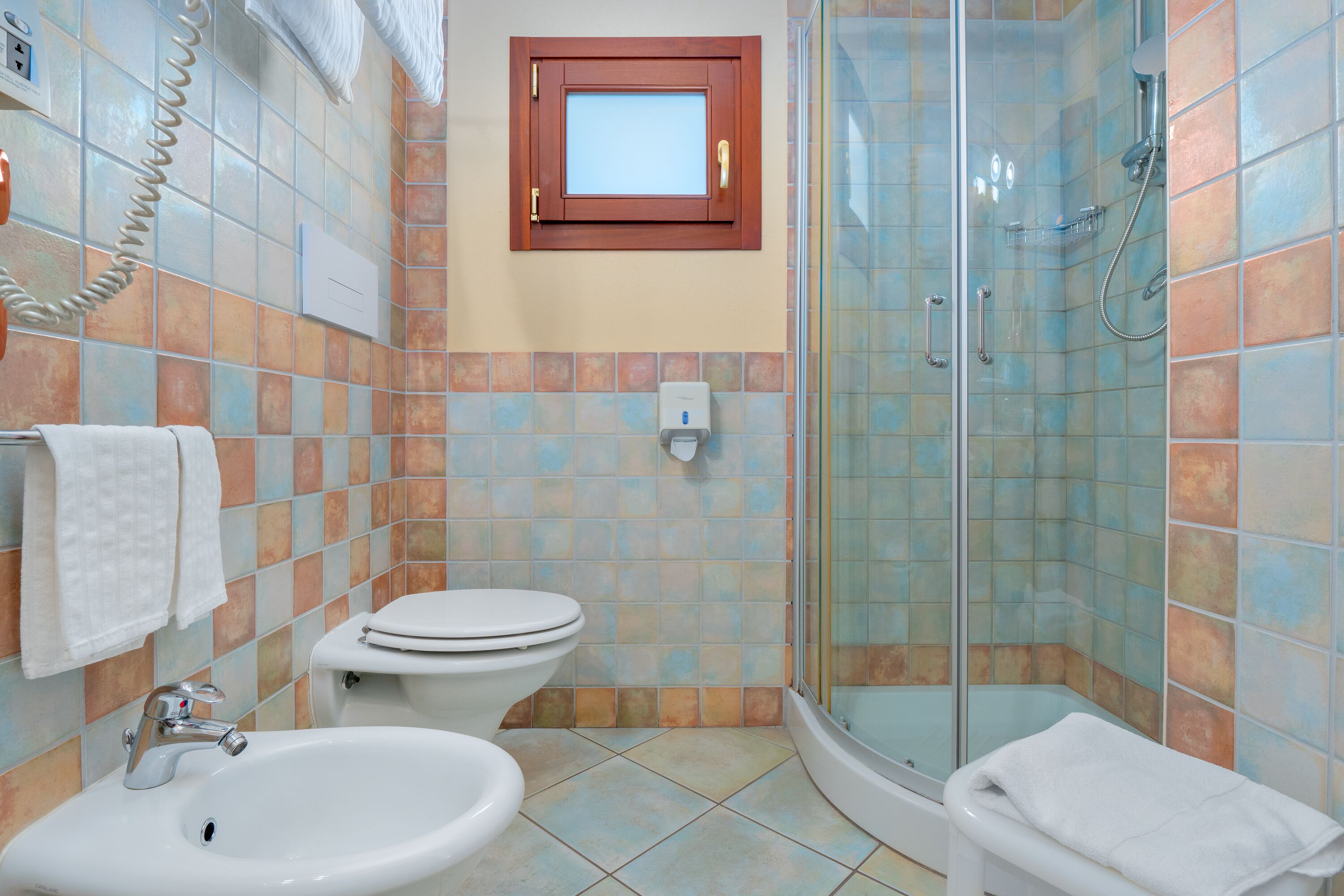 A bathroom with a sink, toilet, and shower.