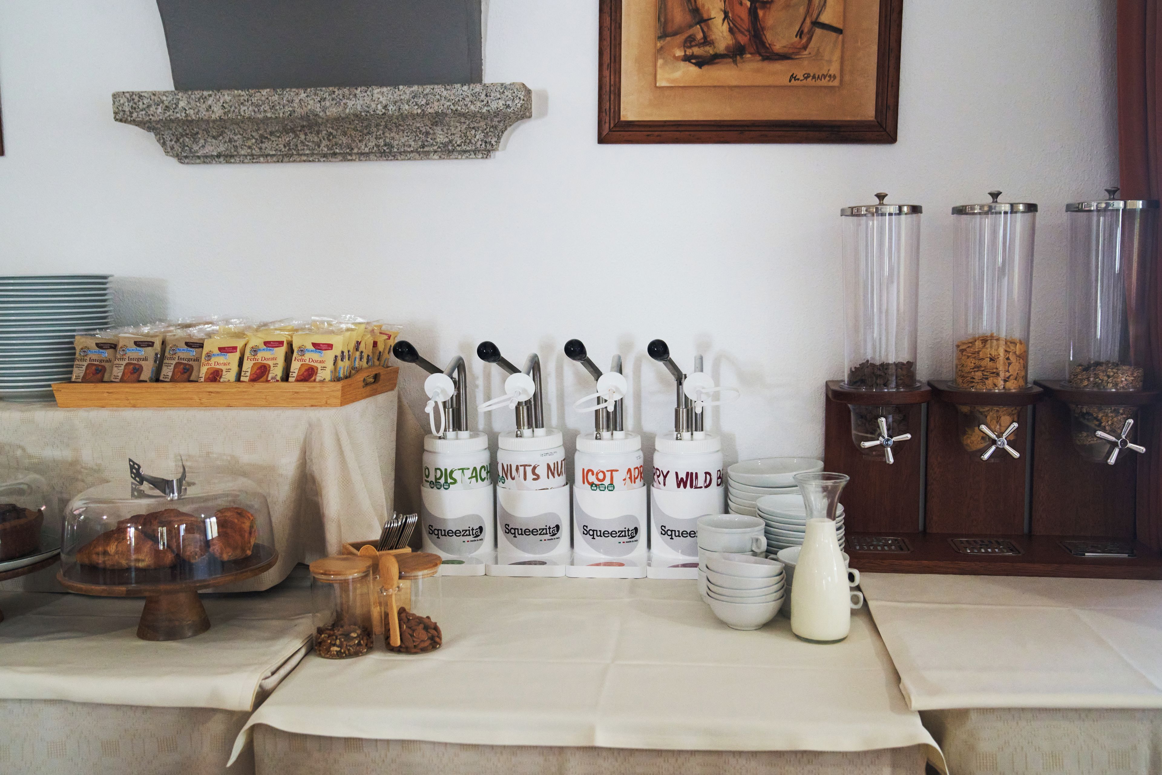 A buffet setup with various food items and condiments.