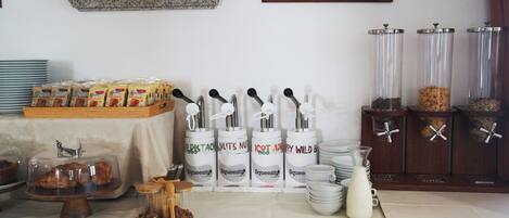 A buffet setup with various food items and condiments.