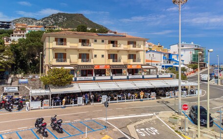 A multi-story building with outdoor seating and a restaurant named "Ristorante".