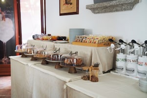 A buffet table with various food items and condiments.