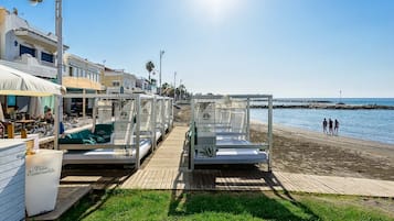 On the beach, sun loungers, beach umbrellas