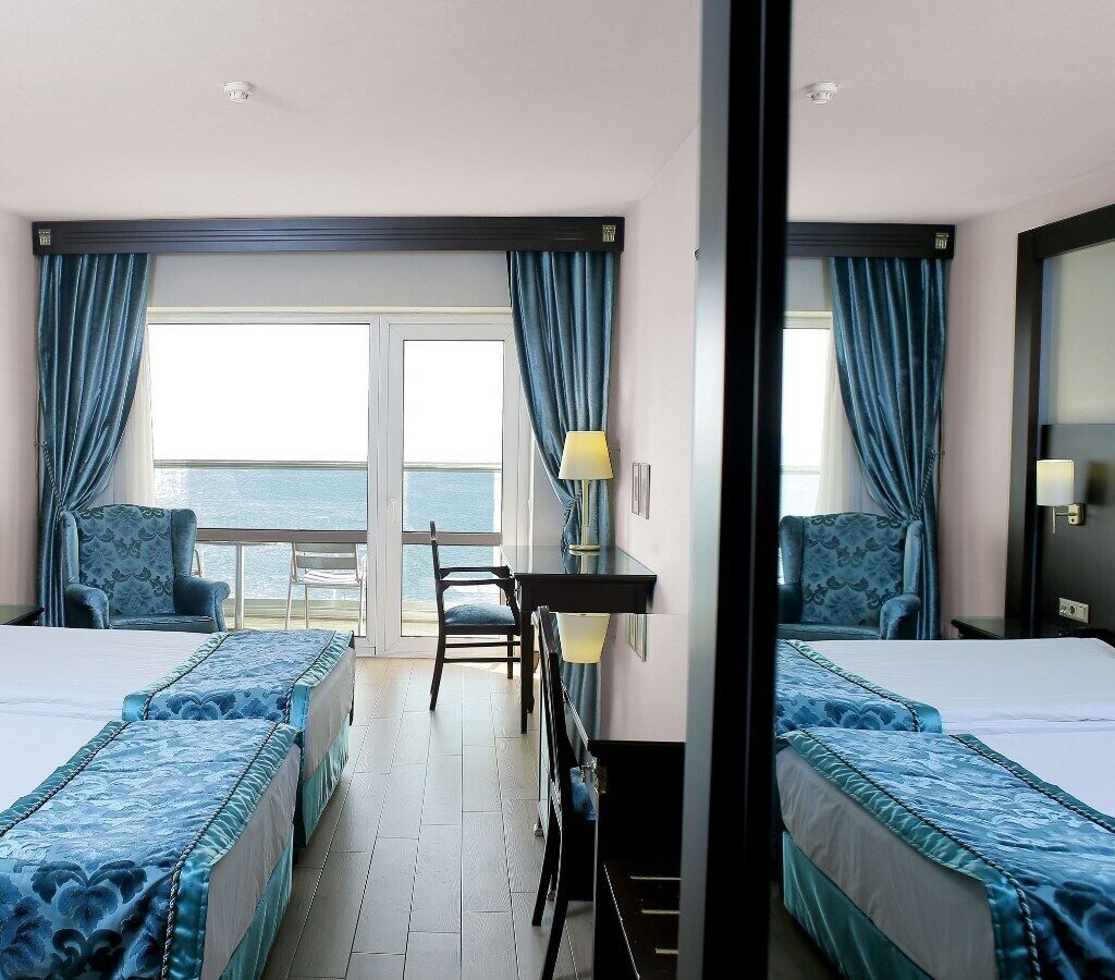 standard twin room, sea view | minibar, in-room safe, desk, free cots/infant beds