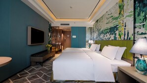 A hotel room with a large bed, a flat-screen TV, a desk with a lamp, and a large abstract painting on the wall. - Chengdu Tianfu Sunshine Hotel (Chengdu)