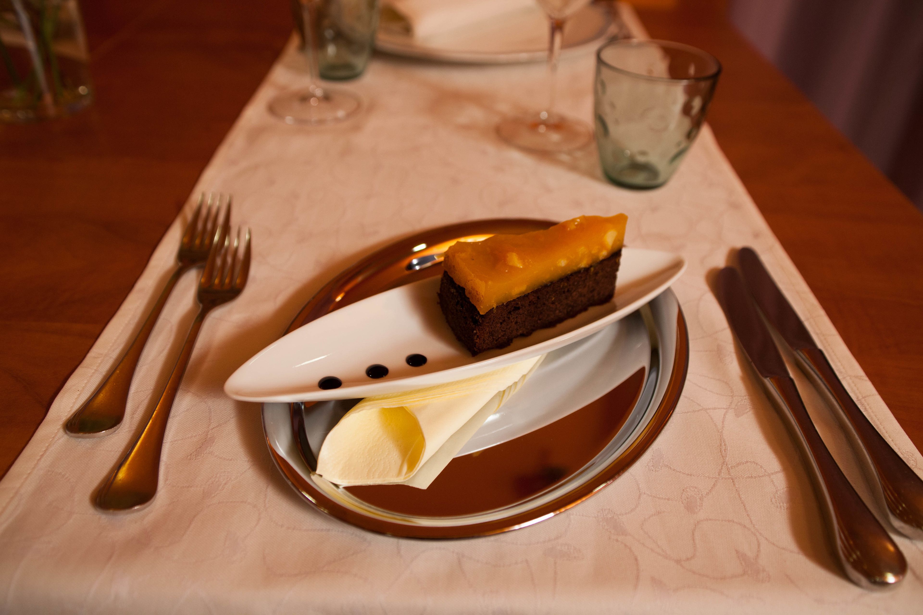 A dessert on a plate with a fork and knife beside it.