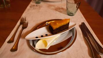 A dessert on a plate with a fork and knife beside it.