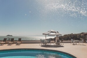 Outdoor pool, open 9:00 AM to 8:00 PM, pool umbrellas, pool loungers