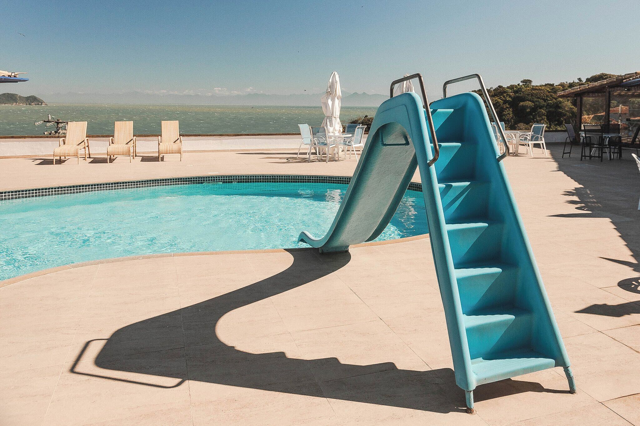 outdoor pool, open 9:00 am to 8:00 pm, pool umbrellas, pool loungers