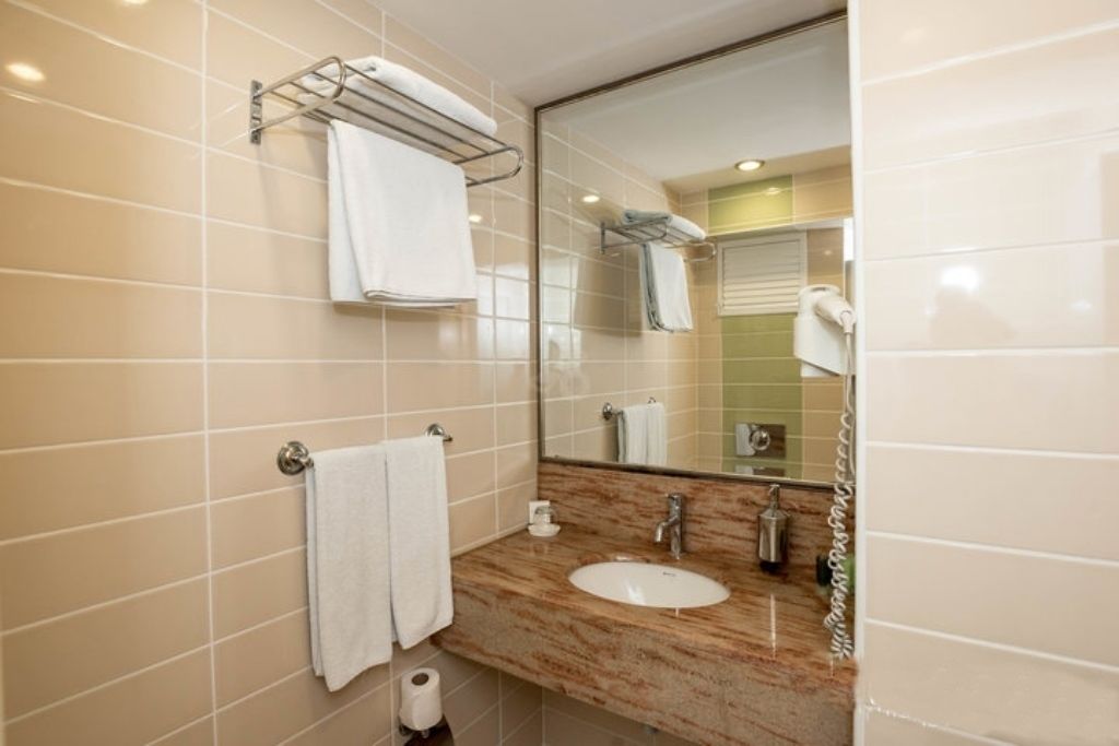 standard room, sea view (single use) | bathroom | shower, hair dryer, slippers, towels