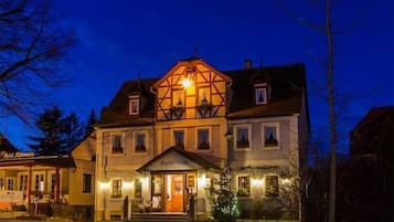 Experience the charm of a traditional European-style hotel with a welcoming atmosphere and a beautifully maintained lawn.