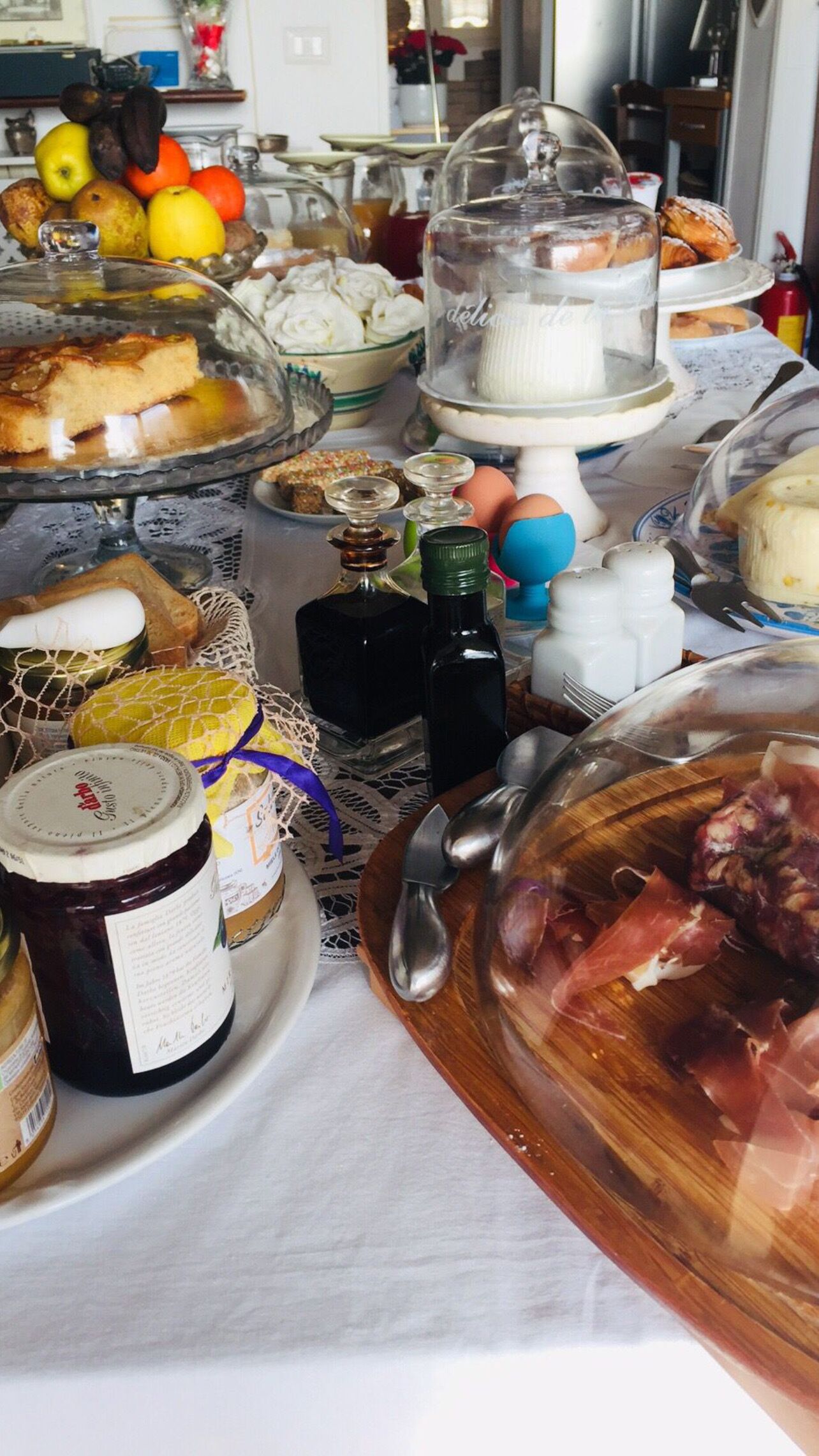 A table with various food items, including pastries, fruits, and condiments.
