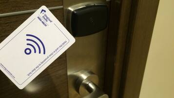 A door with a card reader and a keycard.