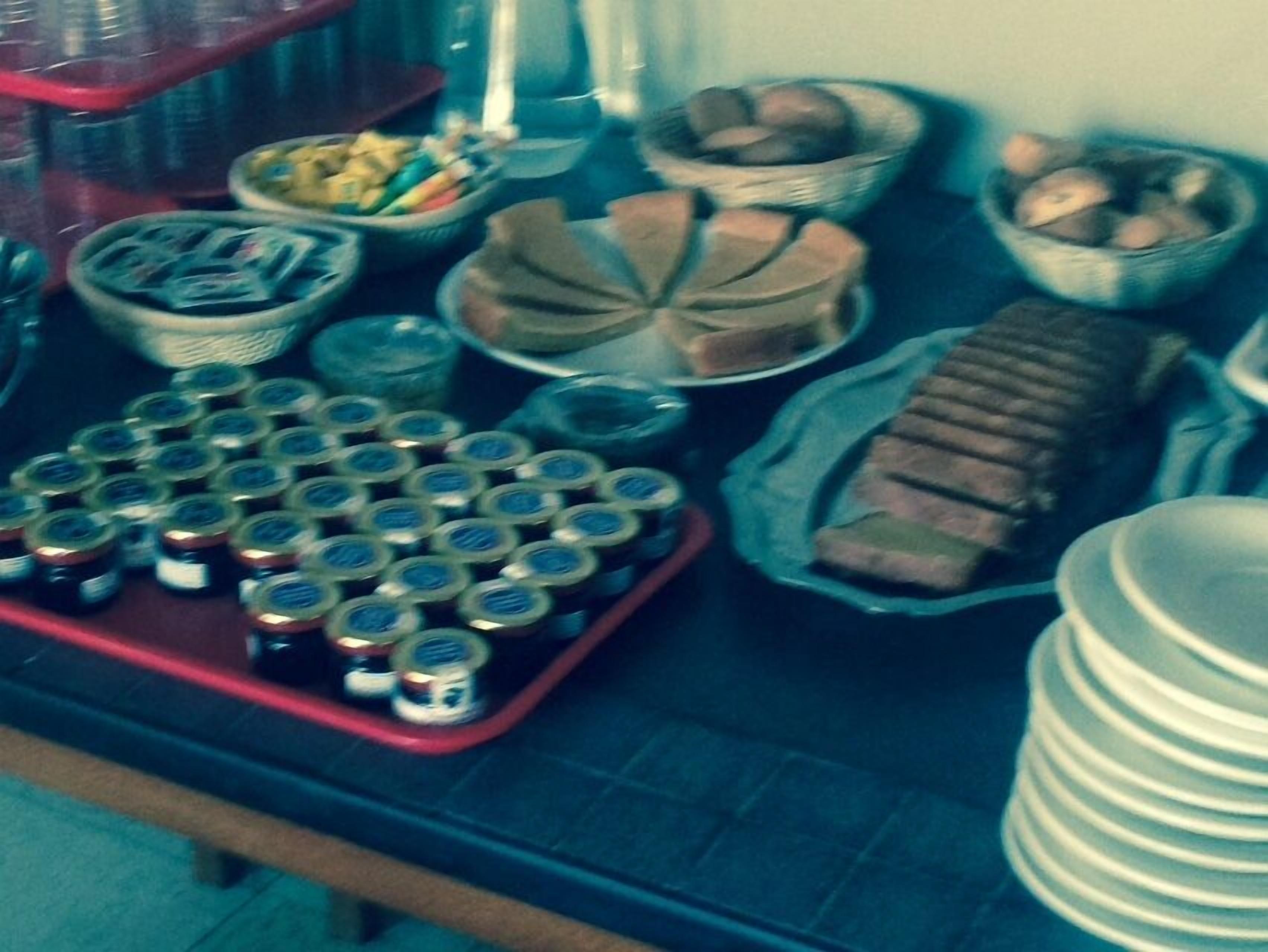 Ein Tisch mit verschiedenen Speisen, darunter Gläser, Körbe und ein Brot.