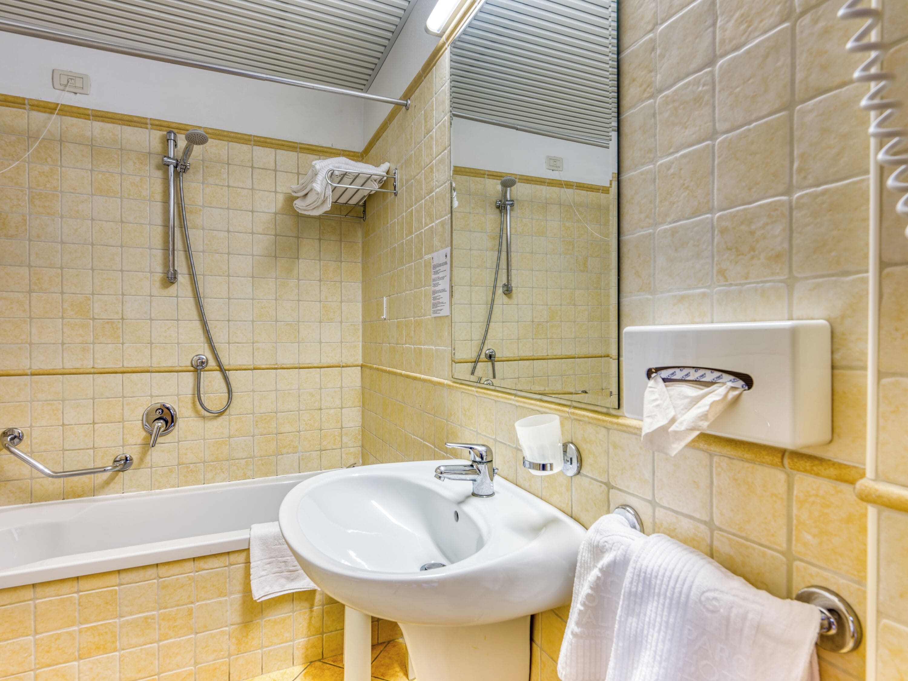 A bathroom with a bathtub, a sink, and a shower.