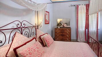 A bedroom with a bed, dresser, and a mirror.