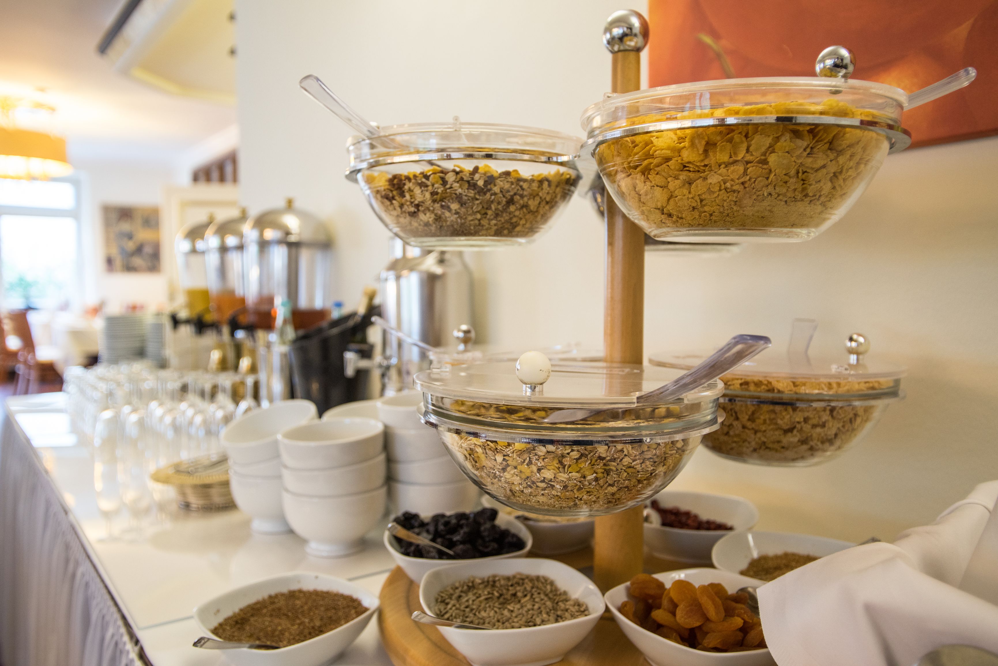 A buffet with various food items in clear bowls and containers.