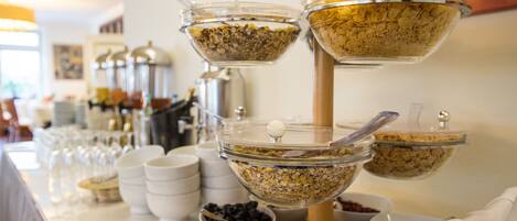 A buffet with various food items in clear bowls and containers.